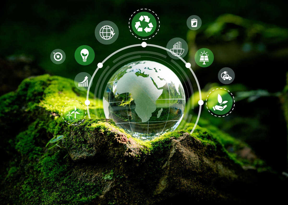 Glass globe on mossy forest bed surrounded by icons of sustainability such as recycling, green energy, and eco-friendly transportation, symbolizing global eco-conscious initiatives.