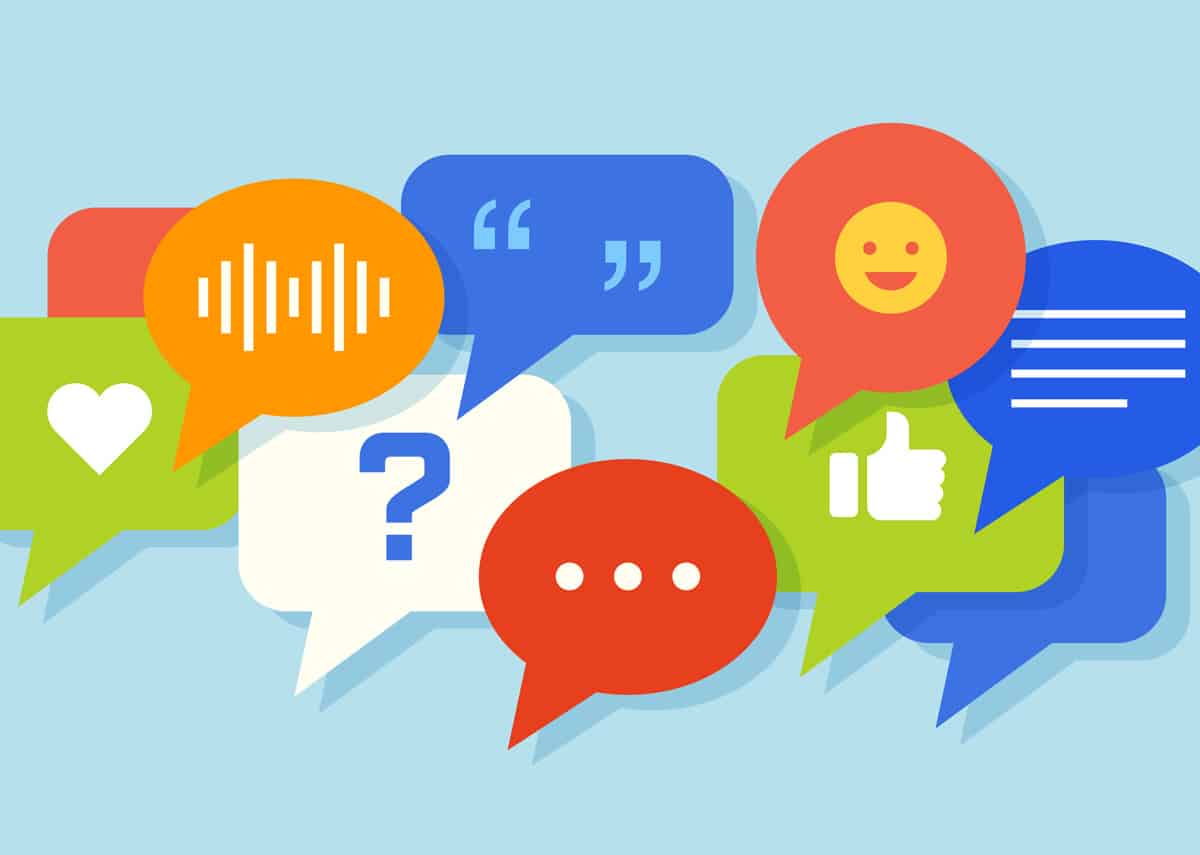 Illustration of colourful speech bubbles featuring social media icons such as a heart, thumbs up, quotation marks, smiley face, and question mark—representing digital conversations and online engagement.